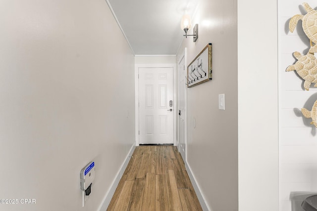 hall with baseboards and wood finished floors