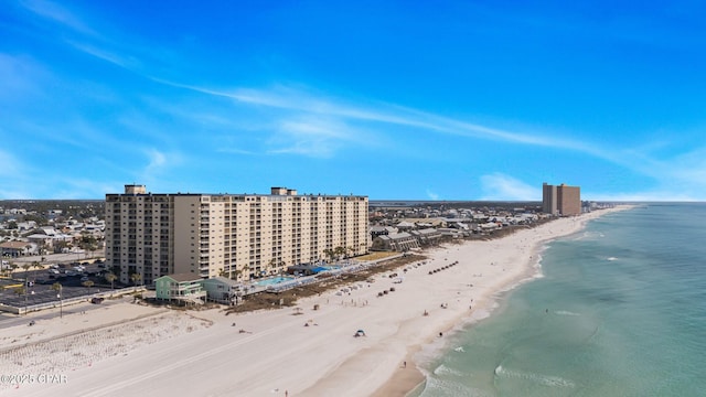 bird's eye view with a water view, a view of the beach, and a city view