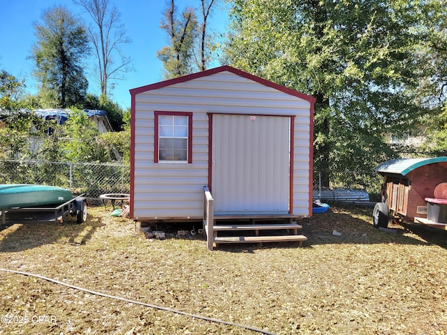 view of shed featuring fence