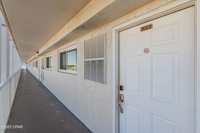 entrance to property featuring stucco siding