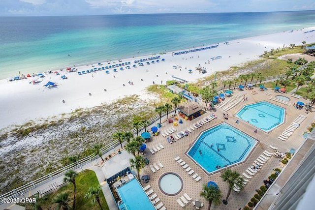 bird's eye view with a water view and a beach view