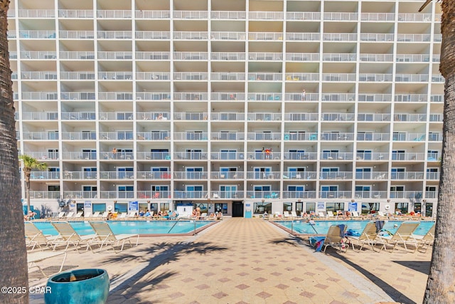 view of building exterior featuring a community pool