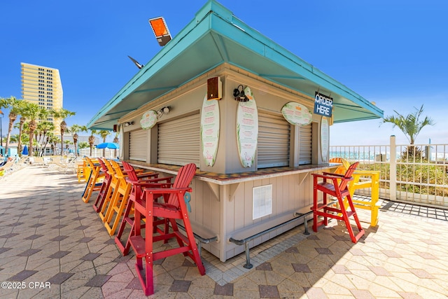 view of patio with fence and outdoor dry bar