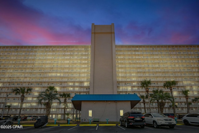 view of building exterior with uncovered parking