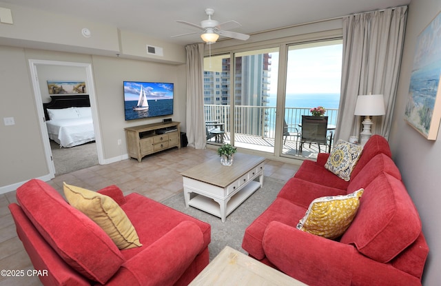 living room featuring a ceiling fan, visible vents, and baseboards