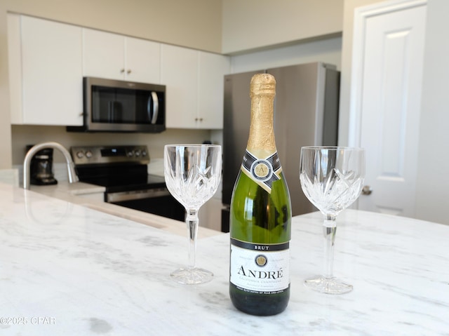 room details with appliances with stainless steel finishes and white cabinets