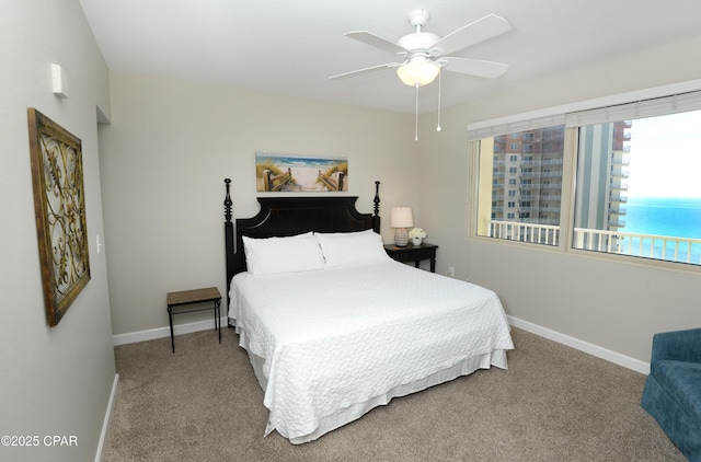 carpeted bedroom featuring a ceiling fan and baseboards