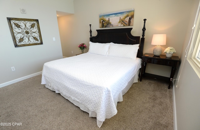 carpeted bedroom featuring baseboards