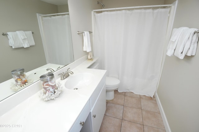 bathroom with toilet, curtained shower, vanity, and tile patterned floors