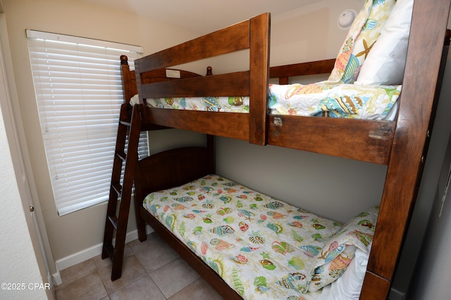 tiled bedroom featuring baseboards