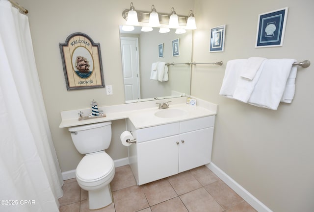 bathroom with toilet, tile patterned flooring, baseboards, and vanity