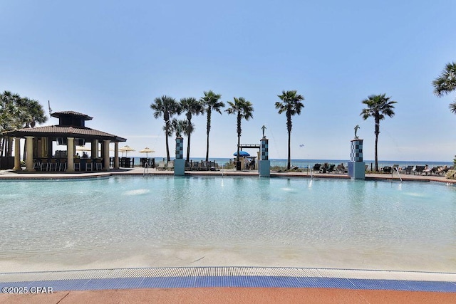 view of pool featuring a water view and a gazebo