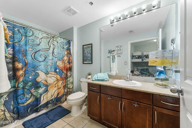 bathroom with visible vents, toilet, a shower with curtain, tile patterned flooring, and vanity