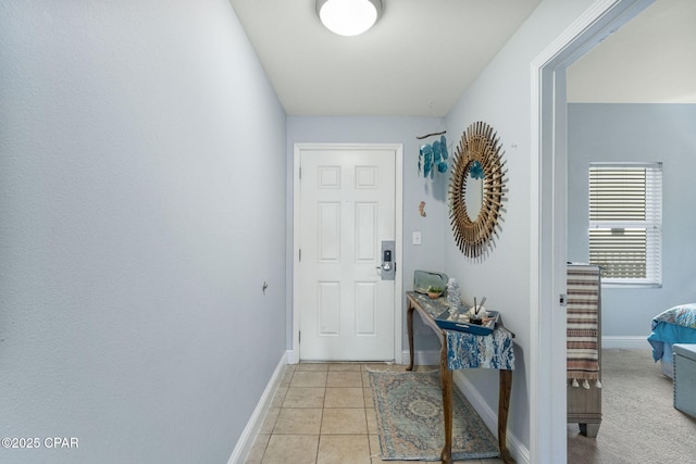 entryway featuring baseboards and light tile patterned flooring