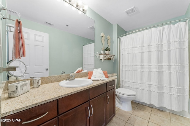 bathroom featuring tile patterned flooring, visible vents, vanity, and toilet