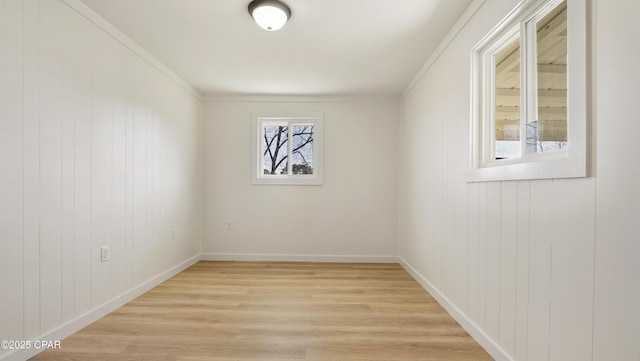 empty room with light wood-type flooring and baseboards