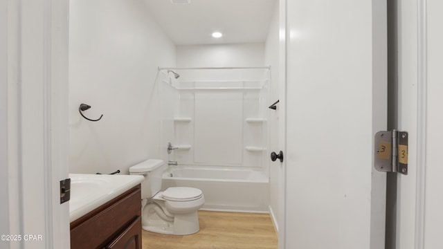 full bathroom with shower / washtub combination, vanity, toilet, and wood finished floors