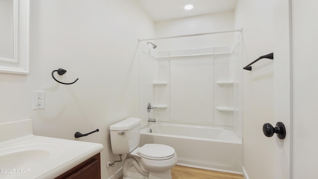 bathroom with toilet, shower / bath combination, wood finished floors, and vanity