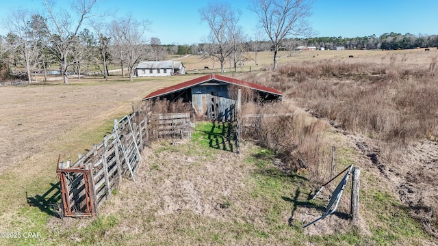 view of outdoor structure featuring a rural view and an outbuilding