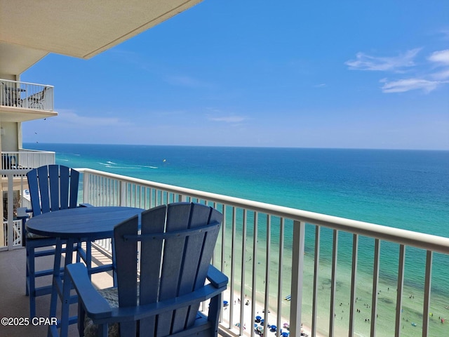 balcony with a view of the beach and a water view