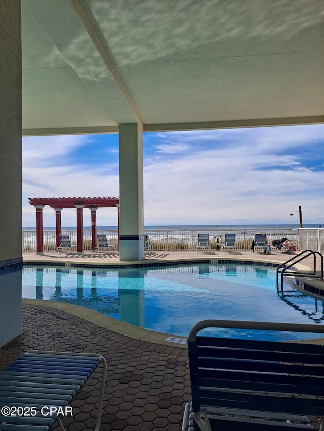 community pool featuring a patio area and a water view