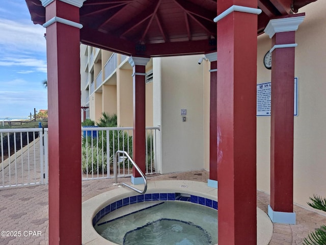 view of swimming pool with a hot tub