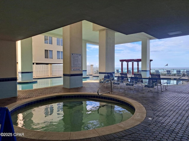 view of swimming pool featuring a community hot tub