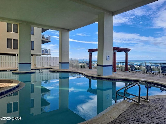 community pool featuring a patio and fence