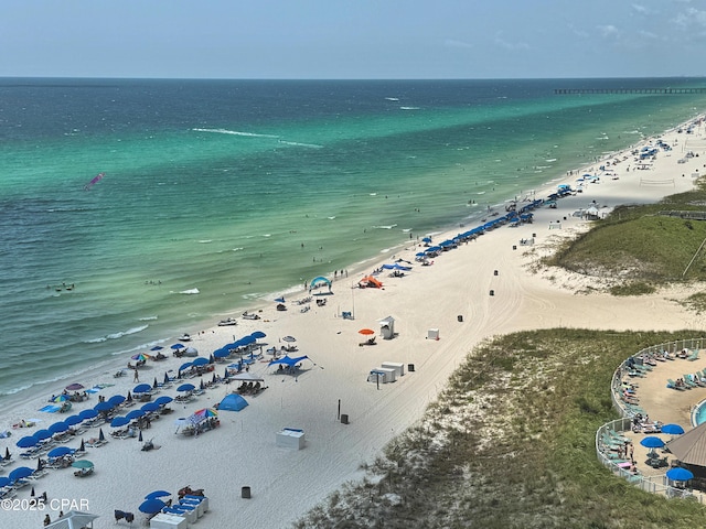 drone / aerial view featuring a water view and a beach view