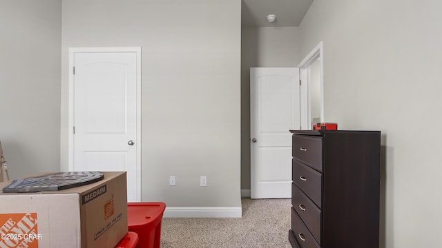 bedroom featuring baseboards and light carpet