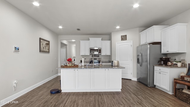 kitchen with visible vents, a kitchen island with sink, white cabinetry, stainless steel appliances, and dark wood-style flooring