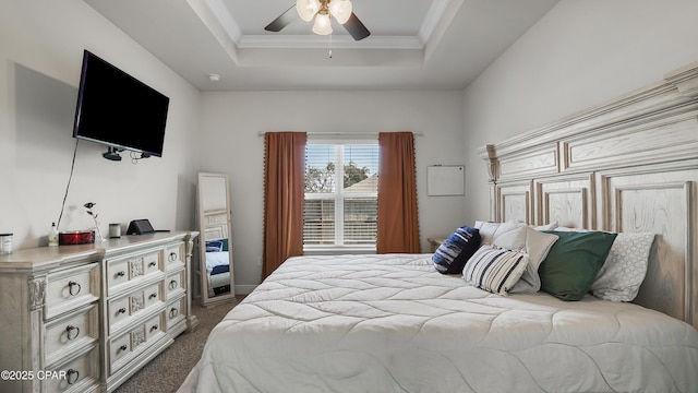 carpeted bedroom featuring ceiling fan, a raised ceiling, and ornamental molding