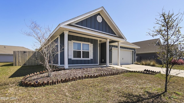 view of front facade featuring a front lawn, board and batten siding, concrete driveway, and an attached garage