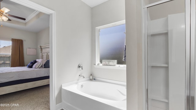 bathroom with a garden tub, ensuite bath, and ceiling fan