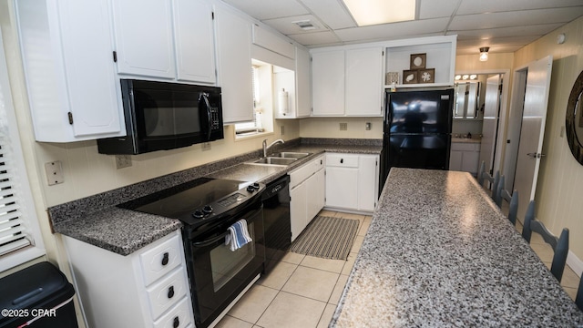 kitchen featuring a sink, black appliances, a drop ceiling, white cabinetry, and open shelves