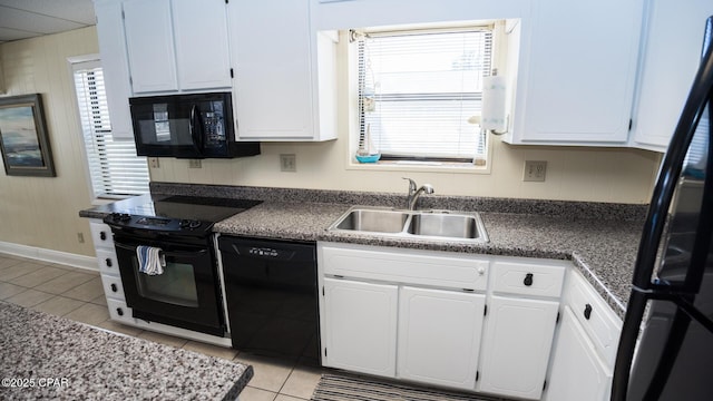 kitchen featuring black appliances, a wealth of natural light, light tile patterned flooring, white cabinetry, and a sink