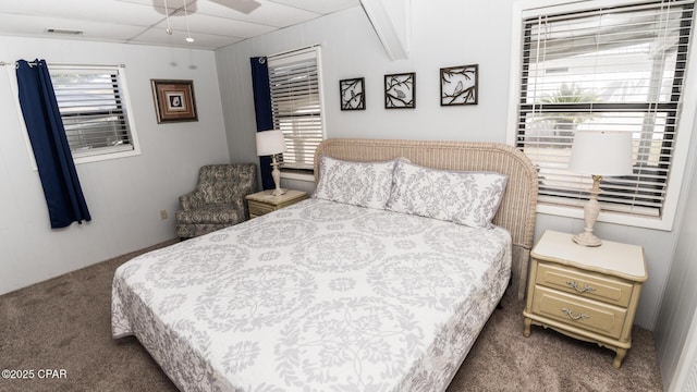 bedroom featuring visible vents, ceiling fan, and carpet flooring