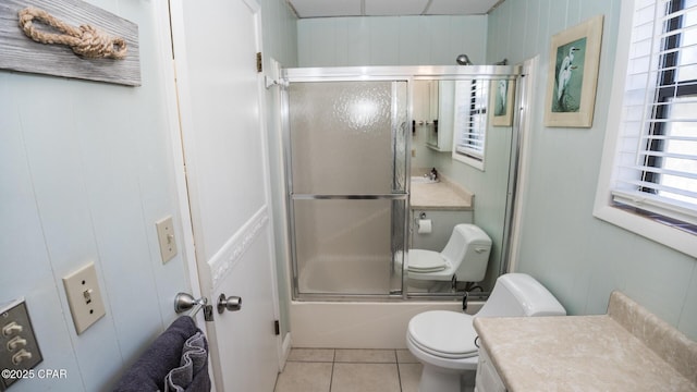 full bath with enclosed tub / shower combo, toilet, vanity, and tile patterned flooring