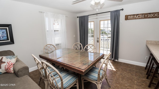 dining room with baseboards and a ceiling fan