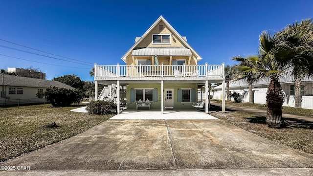 view of front of house featuring fence, stairs, stucco siding, a carport, and driveway