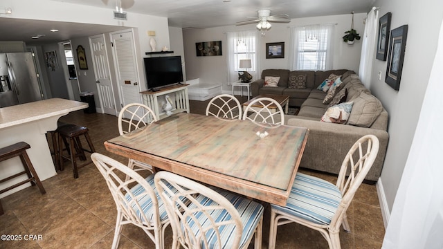 dining space featuring baseboards, visible vents, and ceiling fan