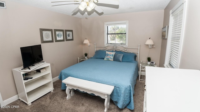 bedroom featuring visible vents, a textured ceiling, carpet floors, baseboards, and ceiling fan