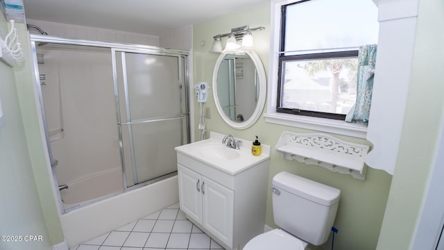 full bathroom with tile patterned flooring, toilet, vanity, and enclosed tub / shower combo