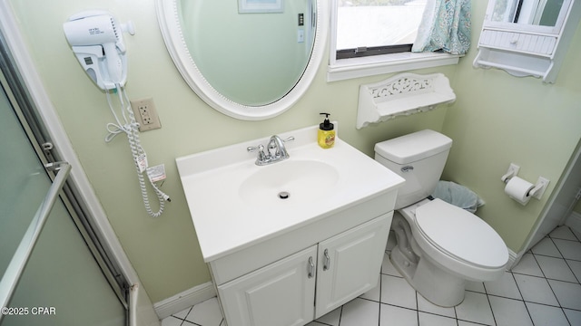 bathroom featuring vanity, tile patterned floors, toilet, and baseboards