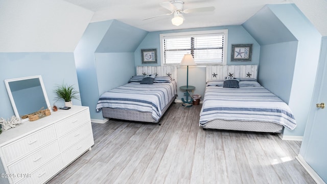 bedroom featuring ceiling fan, baseboards, lofted ceiling, and wood finished floors