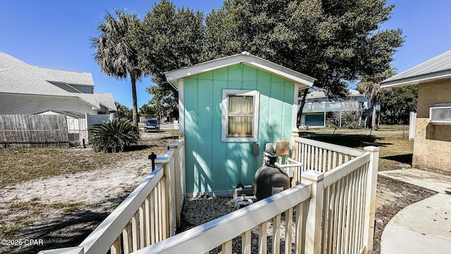 view of outbuilding featuring an outbuilding and fence