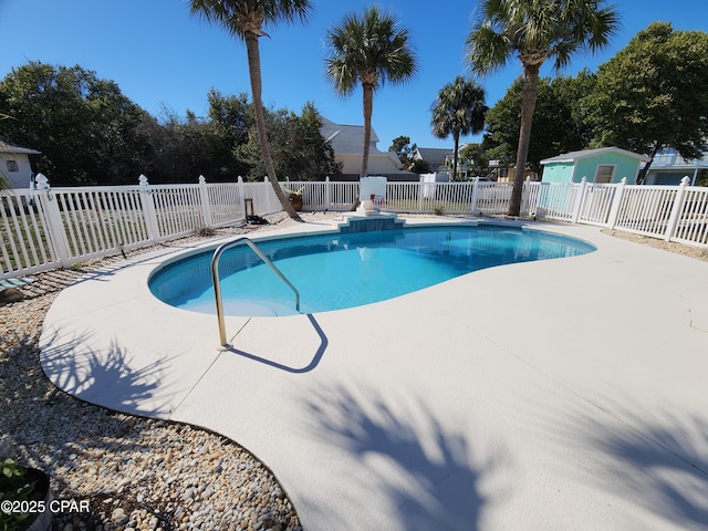 view of pool with an outbuilding, a patio area, a fenced in pool, and fence private yard