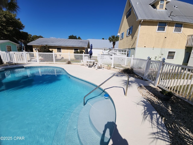 view of swimming pool with a fenced in pool, a patio, and fence