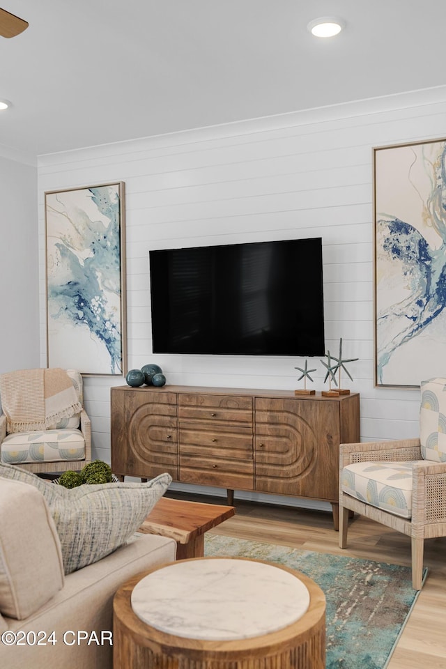 living area with recessed lighting, crown molding, and wood finished floors