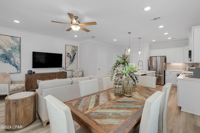 dining room featuring light wood-type flooring, recessed lighting, visible vents, and ornamental molding